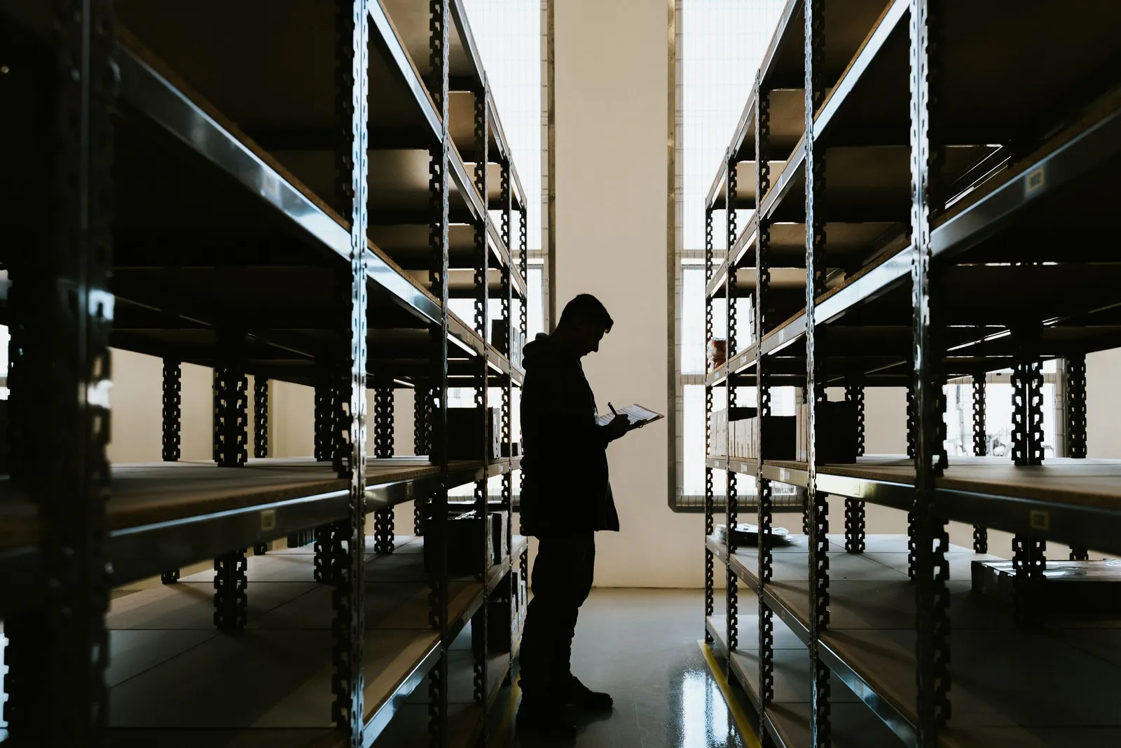 Procurement coordinator reviewing material orders on a construction jobsite